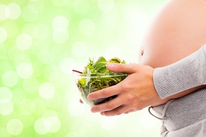 Pregnant women with salad 300x200