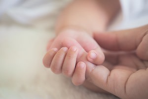 baby holding hand 300x200