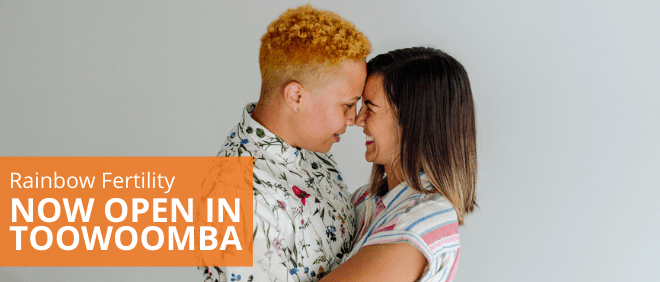 Two people embracing and smiling at each other. Text reading "Rainbow Fertility now open in toowoomba"