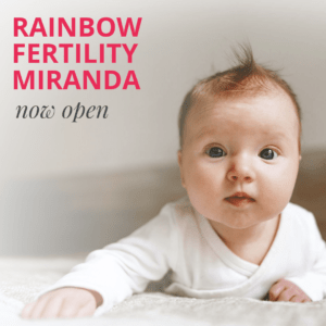 Baby looking at camera with text reading rainbow fertility miranda now open