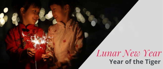 two girls holding sparkler text reading "lunar new year year of the tiger"