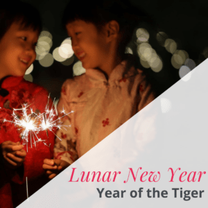 two girls holding sparkler text reading "lunar new year year of the tiger"